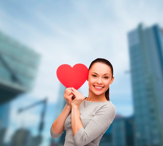 smiling asian woman with red heart