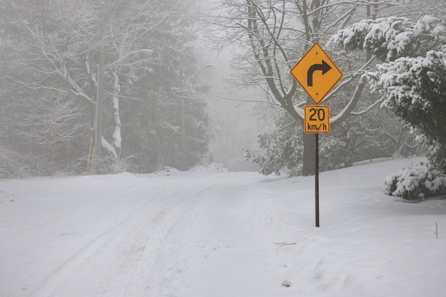 Right turn warning sign on winter road