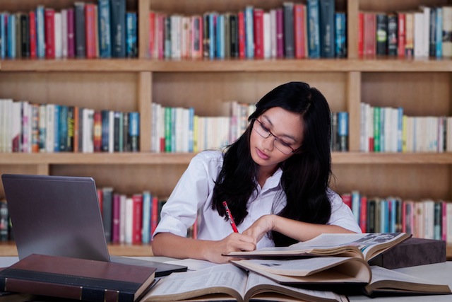 Female student concentrate studying in library