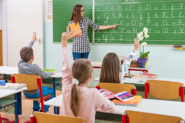 Teacher and students in the classroom: teaching,